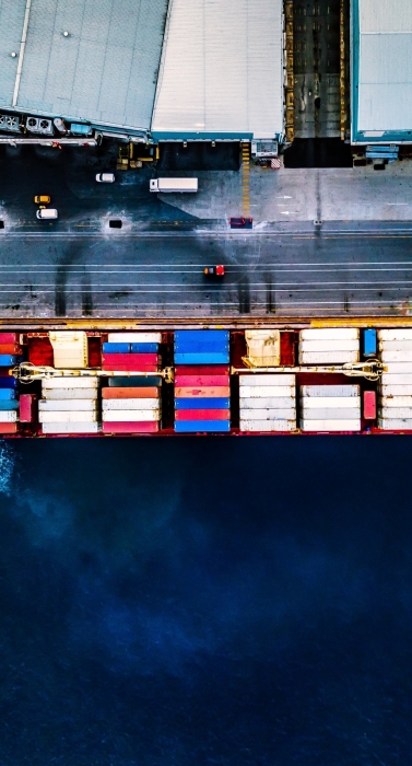 Aerial top view of container ship at sea port