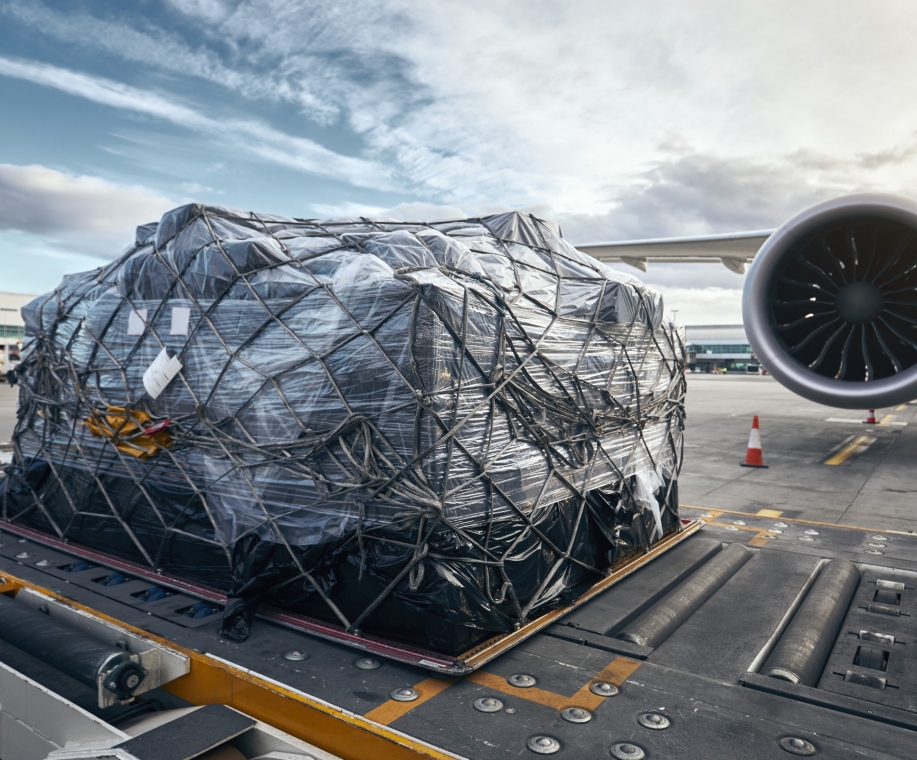 Preparation before flight. Loading of cargo container against airplane.