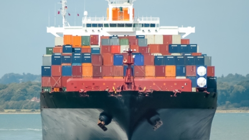 fully loaded container ship head-on in calm water